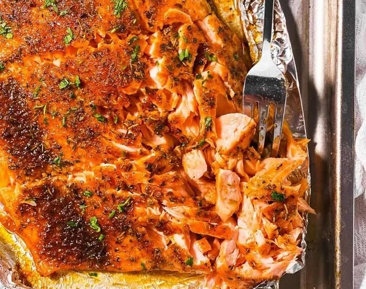 Delicious oven baked salmon with herbs and lemon on a plate